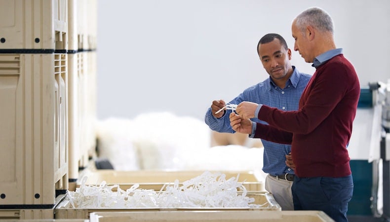 workers debating plastic part design