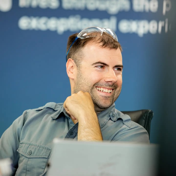 man smiling in conference room